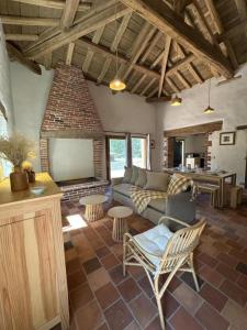 a living room with a couch and a table at Le résinier in Commensacq