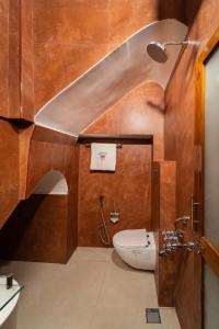 a bathroom with a toilet and a shower at Hotel Palais De Versailles in Pondicherry +148 photos