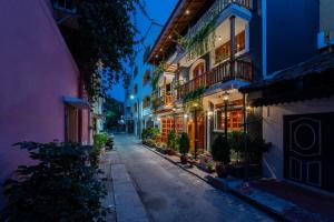 an alley in an old town at night at Hotel Palais De Versailles in Pondicherry