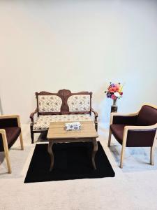 a living room with a bench and a coffee table at Spacious Private Suite Minutes Away from Ocean,Trails and Stores in Langford