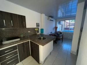 a kitchen with a sink and a counter top at Casa playa crucita in Crucita