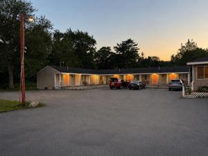 a building with cars parked in a parking lot at Beachway Motel in Salisbury