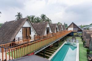 a row of cottages with a pool and a resort at Paragos Silvina's Cabin 2 Resort Hotel in Maitim