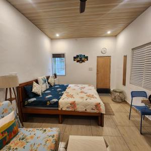 a bedroom with a bed and a couch in it at Sattva Farmstay in Bangalore +63 photos