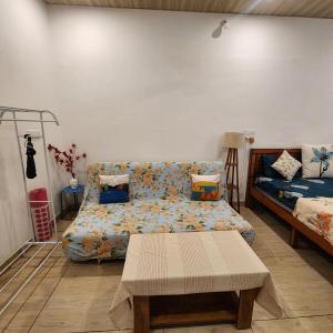 a living room with a couch and a bed at Sattva Farmstay in Bangalore