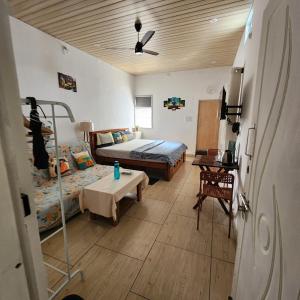 a bedroom with a bed and a table in it at Sattva Farmstay in Bangalore