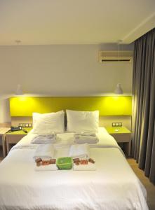 a hotel room with a bed with two trays on it at Elements Rooms & Apartments in Athens