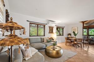 a living room with a couch and a table at Riveresque - Spa Bath - Forest Views in Margaret River Town +18 photos