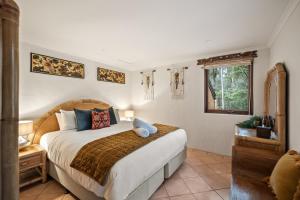a bedroom with a large bed and a window at Riveresque - Spa Bath - Forest Views in Margaret River Town