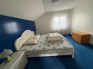 a bedroom with a bed and a wooden dresser at Elegant house in a dominant position in Tour de Treme