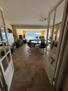 a living room with a table and a dining room at Elegant house in a dominant position in Tour de Treme