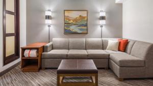 a living room with a couch and a table at BNA Suites in Nashville