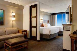 a hotel room with two beds and a couch at BNA Suites in Nashville