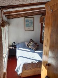 a bedroom with a bed with a pillow on it at Cabañas mirasol in Algarrobo