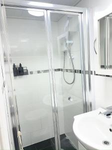 a bathroom with a shower and a sink at The Annex EV 10 per night in Southport