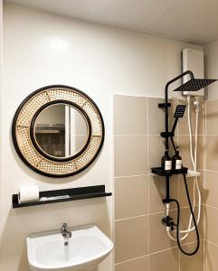 a bathroom with a sink and a mirror on the wall at Casa De Baguio in Town Center in Baguio