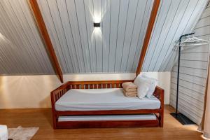 a small bed in a room with a ceiling at Paragos Silvina's Cabin 2 Resort Hotel in Maitim