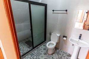 a bathroom with a toilet and a sink at Paragos Silvina's Cabin 2 Resort Hotel in Maitim +23 photos