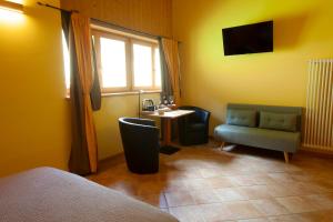 a bedroom with a desk and a chair and a table at Chalet Chapeau RaR in Castel Condino