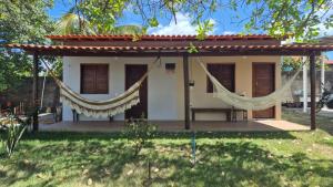 a small house with hammocks in a yard at Chalé Renilton Turismo in Santo Amaro +39 photos