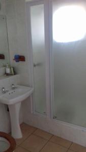 a bathroom with a shower and a sink at Stella Maris Apartment 132 in Amanzimtoti