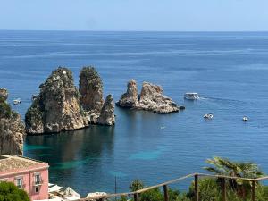 a view of the ocean with rocks in the water at Butterfly Apartments in Palermo