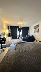 a bedroom with a bed and a living room at kenneth's Home in Stockholm