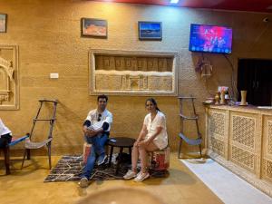 a man and a woman sitting in a room at Sunrise Resort Jaislamer in Jaisalmer
