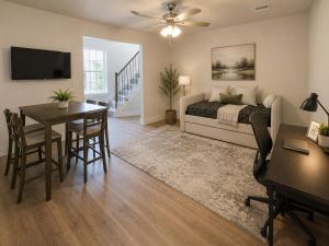 a bedroom with a bed and a table and a desk at Collin Creek Executive Residence in Plano