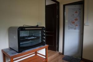 a television sitting on a table next to a door at Honey Home Pai in Pai