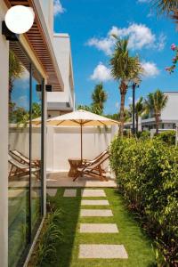 a patio with an umbrella and a table and chairs at Vip villa in Phú Quốc