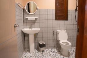 a bathroom with a sink and a toilet and a mirror at Honey Home Pai in Pai +27 photos