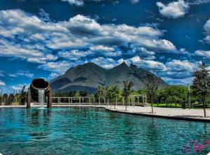 a swimming pool with a mountain in the background at Las Minervas in Monterrey