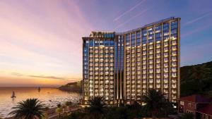 a rendering of a tall building next to the ocean at Khác Sạn Oytes Bay in Xa Thang Nhi