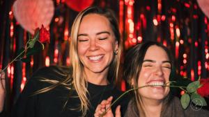 two women standing next to each other holding a rose at UNPLAN Shinjuku in Tokyo +77 photos