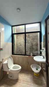 a bathroom with a toilet and a sink at Pharping StayInn in Pharping