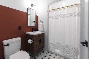 a bathroom with a shower and a toilet and a sink at Lokis Loft and Cellar at the 1896 Building in Kaslo +44 photos