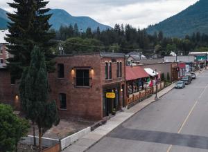 an empty street in a small town with a tree at Lokis Loft and Cellar at the 1896 Building in Kaslo