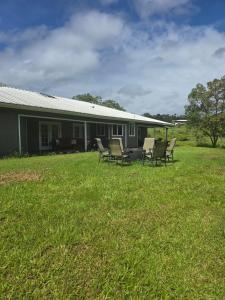 a group of chairs sitting outside of a house at Hale Kululoa in Hilo