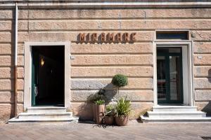 a building with a door and two potted plants in front at Hotel Miramare in Pietra Ligure +16 photos