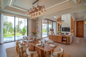a dining room with a large table and chairs at Silk Path Dong Trieu Golf Course & Villas in Trại Sưu