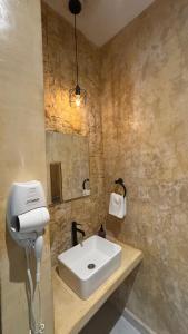 a bathroom with a white sink and a mirror at Petra By Ariché in Valladolid