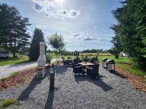 a group of tables and chairs on a gravel road at Wohnwagen Nele in Schwarzbach