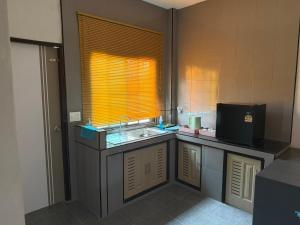 a small kitchen with a sink and a window at 786ResortSungaiGolok in Kampong Baka