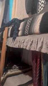 a pile of clothes on a shelf in a closet at My Little Hostel in Monterrey