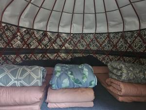 a group of pillows sitting on a bed in a igloo at Kerben yurt camp in Mineralʼnyy Istochnik Altyn-Arasan