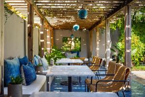 an outdoor patio with tables and chairs and lights at Hotel Saint Cecilia in Austin