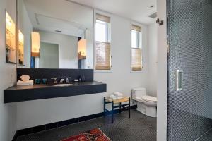 a bathroom with a sink and a mirror and a toilet at Hotel Saint Cecilia in Austin +146 photos