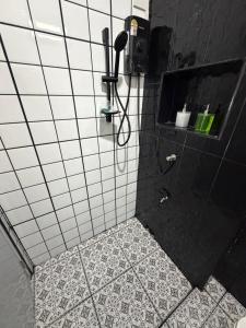 a bathroom with a shower with a phone on the wall at 786ResortSungaiGolok in Kampong Baka +17 photos