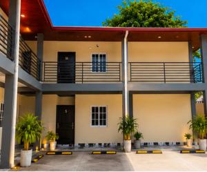 a building with palm trees in front of it at hotel harmony in El Edén